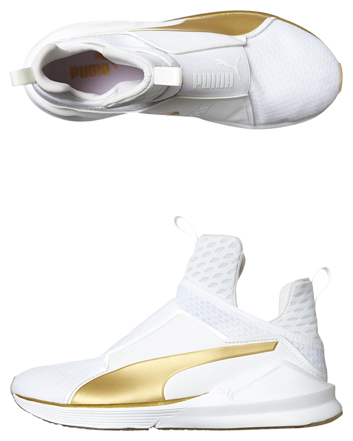 white and gold puma shoes